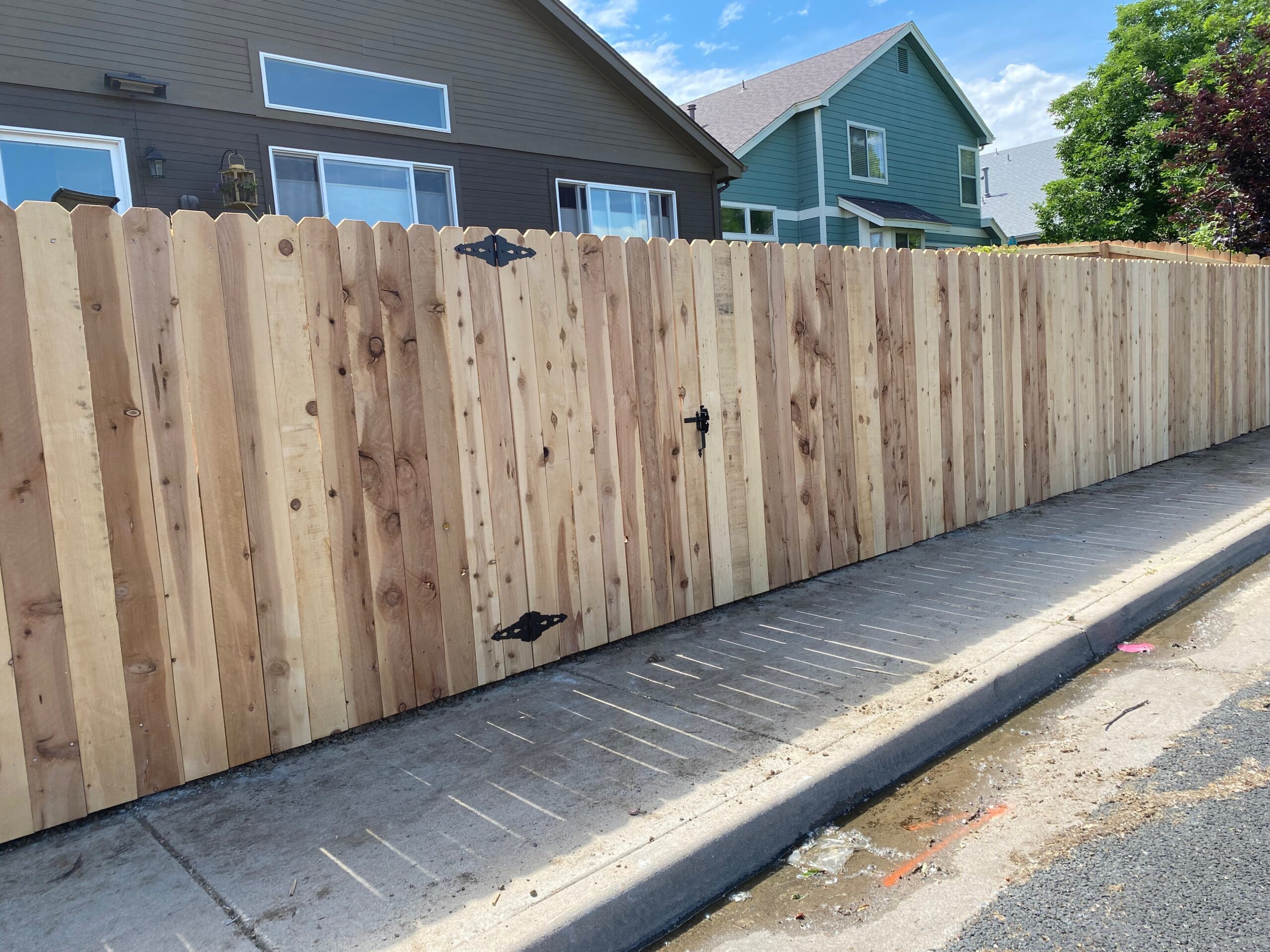 Rustic Cedar Fence 
installed in street with blend in cedar gate